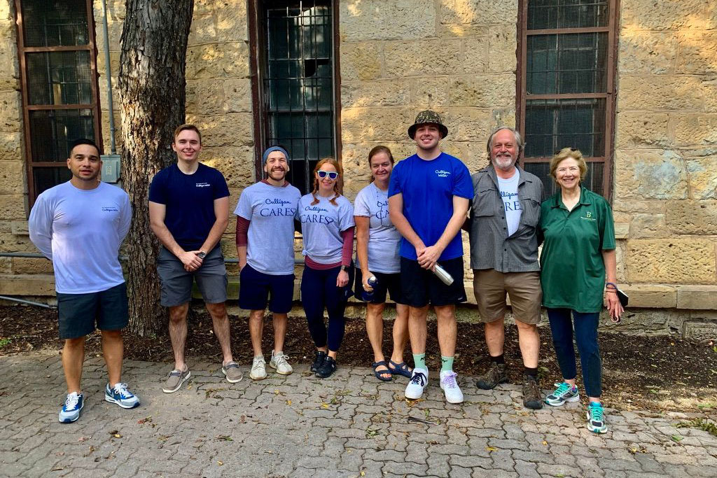 Employees and family members of Culligan of San Antonio clean up Brackenridge Park in San Antonio, TX.